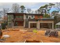 Modern home exterior under construction, featuring stone and wood accents at 4123 Rockingham Dr, Raleigh, NC 27609