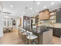 Modern kitchen features a large island with barstool seating, stainless appliances, and pendant lighting at 4123 Rockingham Dr, Raleigh, NC 27609