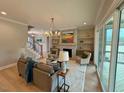 Inviting living room with stone fireplace, open layout, and plenty of natural light at 165 Inspiration Way, Fuquay Varina, NC 27526