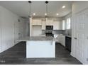 Bright kitchen featuring stainless appliances, ample counter space and a central kitchen island at 189 Waterwheel Dr, Selma, NC 27576