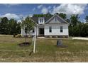 Charming two-story home with white and grey siding and a well-manicured lawn at 35 Uptown Rd, Zebulon, NC 27597