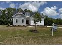 Charming two-story home with white and grey siding and a well-manicured lawn at 35 Uptown Rd, Zebulon, NC 27597