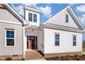 Inviting front entrance with a beautiful wood door and brick steps leading to the home at 35 Uptown Rd, Zebulon, NC 27597