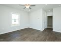 Bedroom features wood-look floors, ceiling fan, and walk-in closet at 121 Ambergate Ct, Rocky Mount, NC 27804