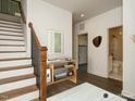 Inviting entryway featuring staircase, console table, and doorway to bath at 1535 Urban Trace Ln, Raleigh, NC 27608