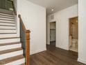 Inviting entryway featuring staircase and doorway to bath at 1535 Urban Trace Ln, Raleigh, NC 27608