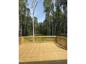 Lovely back deck with wooden railings overlooks a lush, green wooded area at 60 Lemon Drop Ln, Franklinton, NC 27525