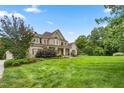 House exterior showcasing a spacious lawn and landscaping at 6366 Lineberry Rd, Liberty, NC 27298