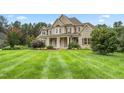 House exterior showcasing a spacious lawn and landscaping at 6366 Lineberry Rd, Liberty, NC 27298
