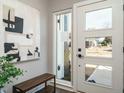Bright and airy entryway with a large door and modern light fixture at 1531 Urban Trace Ln, Raleigh, NC 27608