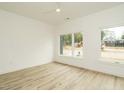 Bright bedroom featuring hardwood floors, large windows and neutral tones at 1533 Urban Trace Ln, Raleigh, NC 27608