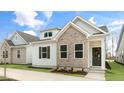 Charming home features a brick facade, white siding, and well-maintained landscaping at 802 Dorset Stream Dr, Fuquay Varina, NC 27526