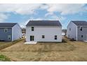 An expansive backyard between two houses, freshly laid sod, and a gray concrete patio at 331 Tormore Dr, Sanford, NC 27330