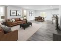 Open-concept living room and dining room with stylish furniture, neutral tones, and plenty of natural light at 331 Tormore Dr, Sanford, NC 27330