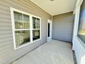 A charming covered porch features outdoor living space, perfect for relaxation and entertaining at 144 Emerson Fields Dr, Pikeville, NC 27863