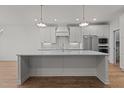 Modern kitchen featuring sleek white cabinets and a large center island at 416 S Cross St, Youngsville, NC 27596