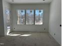 Bright living room features three windows offering natural light and an exterior door at 103 Slocum Dr, Wendell, NC 27591