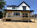 A new home with a spacious deck and railing is a great place to sit and relax outside at 103 Slocum Dr, Wendell, NC 27591