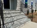 Beautiful stone steps lead to the front door of this new home at 168 Grand Griffon Way, Lillington, NC 27546