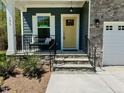This charming home features a cozy front porch and a bright yellow front door at 196 Grand Griffon Way, Lillington, NC 27546
