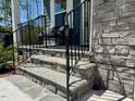Inviting front porch with stone steps, iron railings, and space to relax and enjoy the outdoors at 196 Grand Griffon Way, Lillington, NC 27546