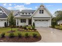 Charming two-story home with white siding, a well-manicured lawn and a two car garage at 414 S Cross St, Youngsville, NC 27596
