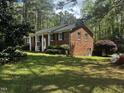 Charming brick home with a well-maintained lawn and mature trees in a peaceful setting at 184 Pine E St, Lillington, NC 27546