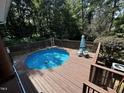 Above-ground pool with a wooden deck, perfect for summer relaxation and outdoor enjoyment at 184 Pine E St, Lillington, NC 27546