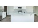 Kitchen island featuring granite countertops and a stainless steel sink at 300 Yellowwood Ave, Spring Hope, NC 27882