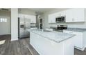 Spacious kitchen featuring stainless appliances, granite countertops, and white cabinets at 300 Yellowwood Ave, Spring Hope, NC 27882