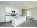 Bright kitchen with stainless appliances, granite countertops, and a functional island at 300 Yellowwood Ave, Spring Hope, NC 27882