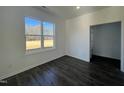 Bedroom with a large window, dark hardwood floors, and neutral-colored walls at 175 W Saltgrass Ln, Smithfield, NC 27577
