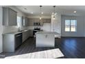 Modern kitchen with stainless steel appliances, granite countertops, and a center island at 175 W Saltgrass Ln, Smithfield, NC 27577