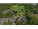 Aerial view showcasing the boundaries of a wooded lot with lush greenery and surrounding mature trees at 222 Kenwood Ln, Pittsboro, NC 27312
