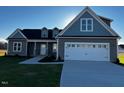 Beautiful one-story home with a two-car garage and a well-manicured front yard at 941 Olive Branch Dr, Smithfield, NC 27577