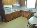 Traditional kitchen with wooden cabinets, an electric stove top, and a breakfast nook with vintage countertops at 1917 New Hill Olive Chapel Rd, New Hill, NC 27562