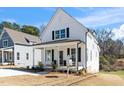 Attractive two-story house with a quaint front porch and well-manicured lawn at 195 N Smith St, Clayton, NC 27520