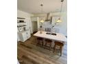 Modern kitchen with stainless steel appliances, a kitchen island, and pendant lighting at 201 N Smith St, Clayton, NC 27520
