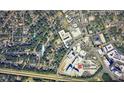 An aerial view showcases the neighborhood's layout, proximity to amenities, and lush green surroundings at 725 Catawba St, Raleigh, NC 27609