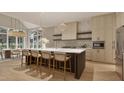 Bright kitchen featuring a large center island with seating, modern pendant lights, and ample cabinet space at 725 Catawba St, Raleigh, NC 27609