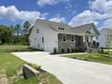 Lovely home showcasing a side-entry garage, stone accents, and a well-manicured lawn at 73 Jumper St, Wendell, NC 27591