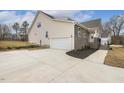 Attached garage with large driveway and landscaping at 73 Jumper St, Wendell, NC 27591