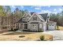 Spacious two-story home featuring gray siding, black roof accents, and a well-manicured front lawn at 30 Chestnut Oak Dr, Youngsville, NC 27596