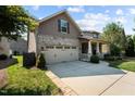 Delightful exterior view featuring an attached two-car garage and a cozy front porch at 4110 Argyle Trl, Burlington, NC 27215