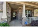 Inviting front porch with classic columns, a secure ADT system, and ample natural light at 4110 Argyle Trl, Burlington, NC 27215