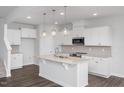Bright kitchen features white cabinets, an island with granite countertops, and stainless steel appliances at 22 Van Winkle St, Lillington, NC 27546