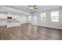 Open living room and kitchen area with hardwood floors at 22 Van Winkle St, Lillington, NC 27546