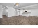 Open living room and kitchen with hardwood floors and stairs at 22 Van Winkle St, Lillington, NC 27546