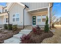 Front view of charming home with gray siding, and a green door at 3911 Willow Gate Way, Raleigh, NC 27604