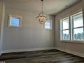 Bright dining room with hardwood floors and large windows at 908 Allen Park Dr, Raleigh, NC 27604